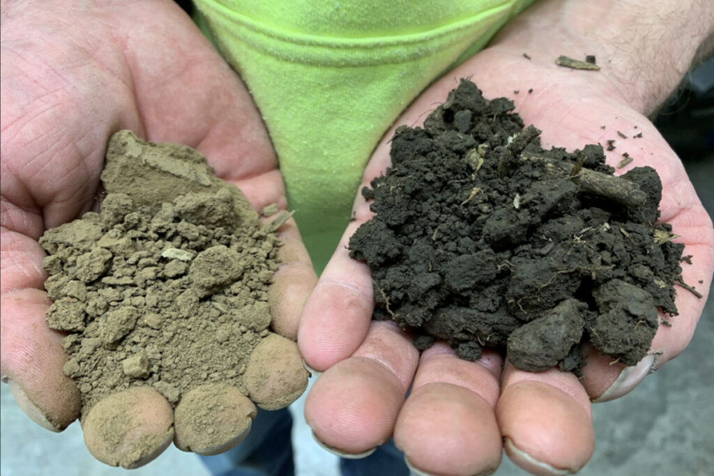 A pair of hands holding depleted soil in the hand on the left, SOC-rich soil on the right.